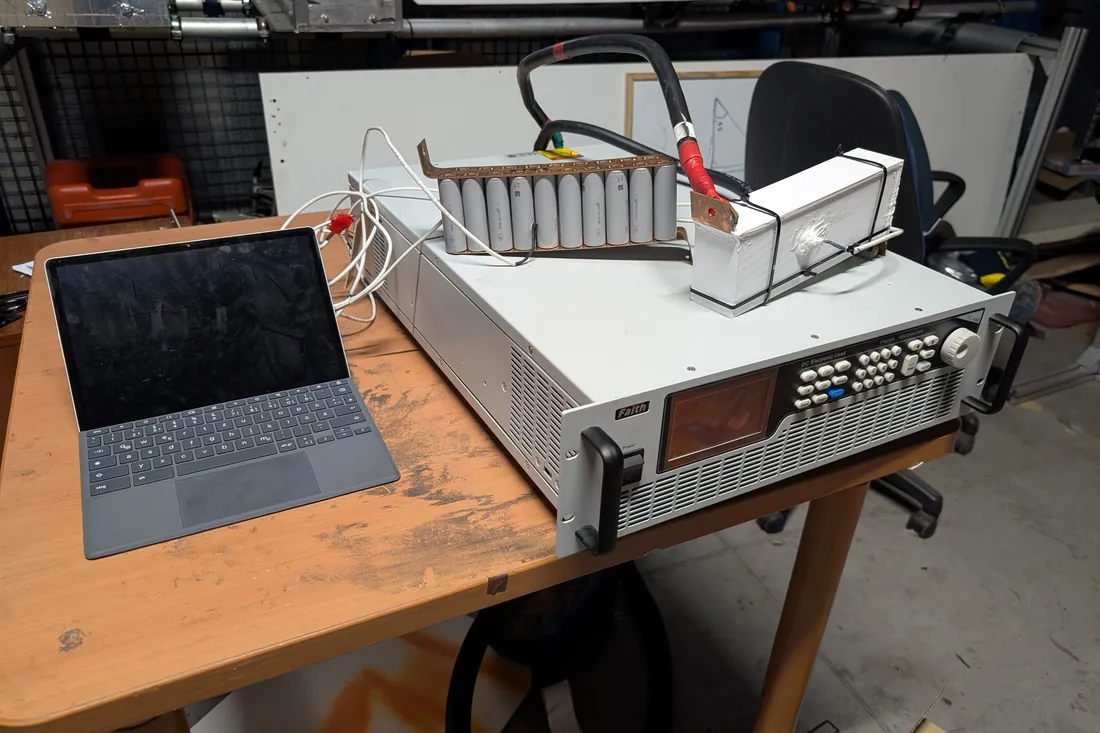 A single module connected to a programmable electronic load beside a laptop on a lab bench